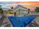 Relaxing backyard oasis features a sparkling blue pool and covered lanai for ultimate enjoyment at 415 W Marion Ave, Punta Gorda, FL 33950