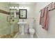 Bathroom featuring a glass-enclosed shower with tiled walls, a pedestal sink, and modern fixtures at 415 W Marion Ave, Punta Gorda, FL 33950