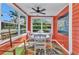 Sunroom dining area features a white table, cushioned chairs, and a vibrant area rug at 415 W Marion Ave, Punta Gorda, FL 33950