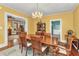 Cozy dining room with wood table and chairs, chandelier, and view into other rooms at 415 W Marion Ave, Punta Gorda, FL 33950