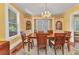 Traditional dining room featuring a chandelier, built-in cabinets, and a beautiful wooden table with six chairs at 415 W Marion Ave, Punta Gorda, FL 33950