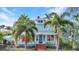 Charming two-story home with a brick walkway, beautiful landscaping, and a welcoming front porch at 415 W Marion Ave, Punta Gorda, FL 33950