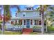 Charming two-story home featuring a brick walkway, beautiful landscaping, and a welcoming front entrance at 415 W Marion Ave, Punta Gorda, FL 33950