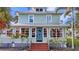 Charming two-story home featuring a brick walkway, beautiful landscaping, and a welcoming front entrance at 415 W Marion Ave, Punta Gorda, FL 33950