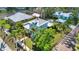 Charming two-story home with a metal roof, lush landscaping, and a welcoming front porch at 415 W Marion Ave, Punta Gorda, FL 33950