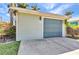 Side view of garage showcasing ample space and well-maintained landscaping at 415 W Marion Ave, Punta Gorda, FL 33950