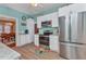 View of kitchen leading to dining area with stainless appliances and light-blue walls at 415 W Marion Ave, Punta Gorda, FL 33950