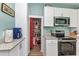 Bright kitchen featuring white cabinets, granite countertops, and stainless steel appliances at 415 W Marion Ave, Punta Gorda, FL 33950