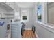 Well-lit laundry room with washer, dryer, and storage shelves at 415 W Marion Ave, Punta Gorda, FL 33950