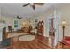 Bright living room with hardwood floors, fireplace, classic furnishings, and an open doorway to the sunroom at 415 W Marion Ave, Punta Gorda, FL 33950