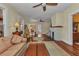 Spacious living room with a fireplace, hardwood floors, a ceiling fan, and comfortable seating at 415 W Marion Ave, Punta Gorda, FL 33950