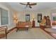 Bright living room with a ceiling fan, hardwood floors, and a comfortable seating arrangement at 415 W Marion Ave, Punta Gorda, FL 33950
