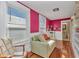 Bright living room with natural light, a cozy couch, and views of the neighborhood at 415 W Marion Ave, Punta Gorda, FL 33950