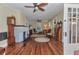 Inviting living room with hardwood floors, a vintage grandfather clock, and ample seating at 415 W Marion Ave, Punta Gorda, FL 33950
