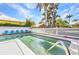Inviting pool area with charming Adirondack chairs and a pristine white picket fence, perfect for relaxation at 415 W Marion Ave, Punta Gorda, FL 33950