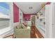 Bright reading nook featuring built-in bookshelves, a comfortable couch, and natural light at 415 W Marion Ave, Punta Gorda, FL 33950