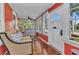 Cozy sunroom with hardwood floors, large windows, and comfortable seating area at 415 W Marion Ave, Punta Gorda, FL 33950