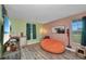 Inviting bedroom with ample natural light, hardwood floors, and cozy orange beanbag at 457 Glenridge Nw Ave, Port Charlotte, FL 33952
