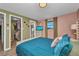 Cozy bedroom featuring a walk-in closet, soothing colors, and a TV atop a modern dresser at 457 Glenridge Nw Ave, Port Charlotte, FL 33952