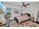 Bright bedroom featuring a modern bed, colorful rug, and ample natural light at 457 Glenridge Nw Ave, Port Charlotte, FL 33952