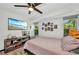 Bright bedroom featuring a modern bed, ample natural light, and TV at 457 Glenridge Nw Ave, Port Charlotte, FL 33952