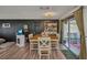 Bright dining area featuring a wooden table, stylish decor, and sliding glass doors to a screened outdoor space at 457 Glenridge Nw Ave, Port Charlotte, FL 33952