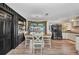 Inviting dining area with a wooden table, modern decor, and sliding glass doors leading to the outdoor space at 457 Glenridge Nw Ave, Port Charlotte, FL 33952