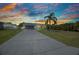 Charming single-story home featuring a well-manicured lawn and a spacious driveway leading to an attached two-car garage at 457 Glenridge Nw Ave, Port Charlotte, FL 33952