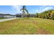 Well-maintained home with lush green lawn, mature trees, and a long driveway at 457 Glenridge Nw Ave, Port Charlotte, FL 33952