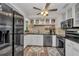 Modern kitchen with stainless steel appliances, white cabinetry, and a functional layout for easy cooking at 457 Glenridge Nw Ave, Port Charlotte, FL 33952