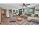 Comfortable living room featuring stylish furniture, a ceiling fan, and natural light from the windows at 457 Glenridge Nw Ave, Port Charlotte, FL 33952