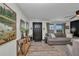 Comfortable living room featuring stylish furniture, a ceiling fan, and natural light from the windows at 457 Glenridge Nw Ave, Port Charlotte, FL 33952