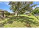 Expansive backyard features mature trees, a tire swing, and plenty of room for outdoor activities and enjoyment at 496 Fletcher St, Port Charlotte, FL 33954