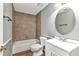 Cozy bathroom with tiled shower and tub, white vanity, and modern fixtures at 496 Fletcher St, Port Charlotte, FL 33954