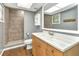 Bathroom featuring tiled walk-in shower and wood-look flooring at 496 Fletcher St, Port Charlotte, FL 33954