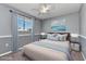 Serene bedroom with soft blue accents, a ceiling fan, and a bright window at 496 Fletcher St, Port Charlotte, FL 33954