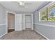 Bedroom with carpet, neutral paint, chair rail, ceiling fan and window with blinds at 496 Fletcher St, Port Charlotte, FL 33954
