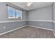 Grey bedroom featuring carpet, window with blinds, chair rail, and ceiling fan at 496 Fletcher St, Port Charlotte, FL 33954