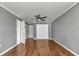 Bedroom featuring a ceiling fan, wood-look floors, and closet at 496 Fletcher St, Port Charlotte, FL 33954