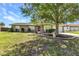 Charming single-story home featuring well-kept landscaping and a cozy, inviting facade under a bright blue sky at 496 Fletcher St, Port Charlotte, FL 33954