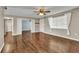 Bright living room with wood floors, ceiling fan, and natural light from a window with curtains at 496 Fletcher St, Port Charlotte, FL 33954