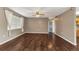 Inviting living room featuring dark wood floors and a large window, creating a warm and welcoming atmosphere at 496 Fletcher St, Port Charlotte, FL 33954