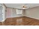 Spacious living room featuring a pink front door, hardwood floors, and abundant natural light at 496 Fletcher St, Port Charlotte, FL 33954