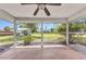 Screened-in lanai overlooks a green backyard and landscaping at 496 Fletcher St, Port Charlotte, FL 33954