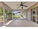 View of the screened patio featuring a ceiling fan, neutral colors, and sliding glass doors leading to the interior of the home at 496 Fletcher St, Port Charlotte, FL 33954