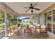 Relaxing screened porch featuring comfortable seating and a ceiling fan at 496 Fletcher St, Port Charlotte, FL 33954