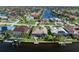 Aerial view of the waterfront home with a screened lanai, beautiful landscaping, and private dock at 531 Madrid Blvd, Punta Gorda, FL 33950