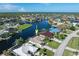 Beautiful aerial showcasing waterfront home with lush landscaping, private dock, and community waterways at 531 Madrid Blvd, Punta Gorda, FL 33950