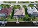 Aerial view showing waterfront property with private dock, landscaped yard, and screened in lanai at 531 Madrid Blvd, Punta Gorda, FL 33950