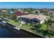 Backyard features waterfront views, a screened lanai, lush landscape and a private boat dock at 531 Madrid Blvd, Punta Gorda, FL 33950